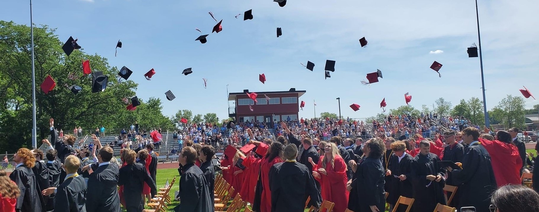graduates tossing their caps